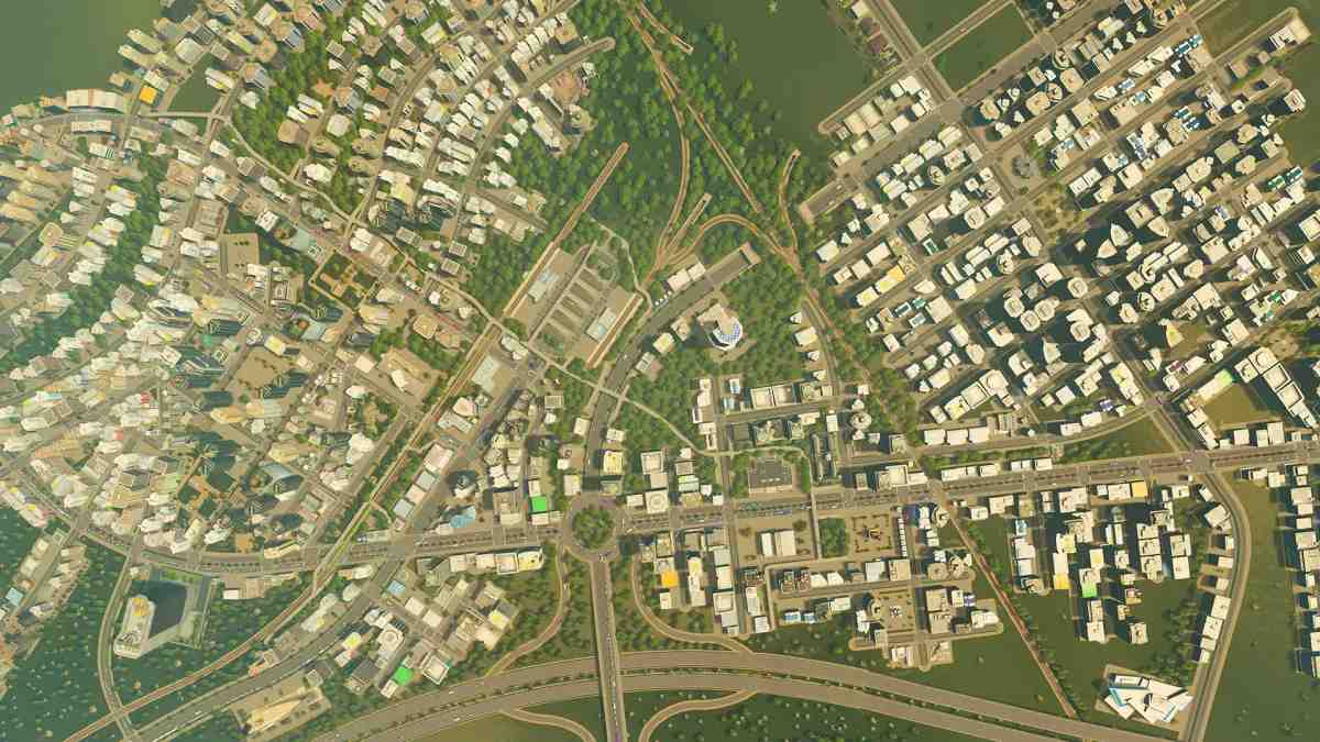Et overblik fra en høj vinkel af et tæt bylayout med veje, boliger og erhvervsbygninger i Cities: Skylines